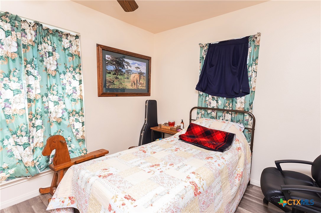 802 Bay Street Austwell, TX 77950 - Photo 15 of 27 a bedroom with a bed and a chair