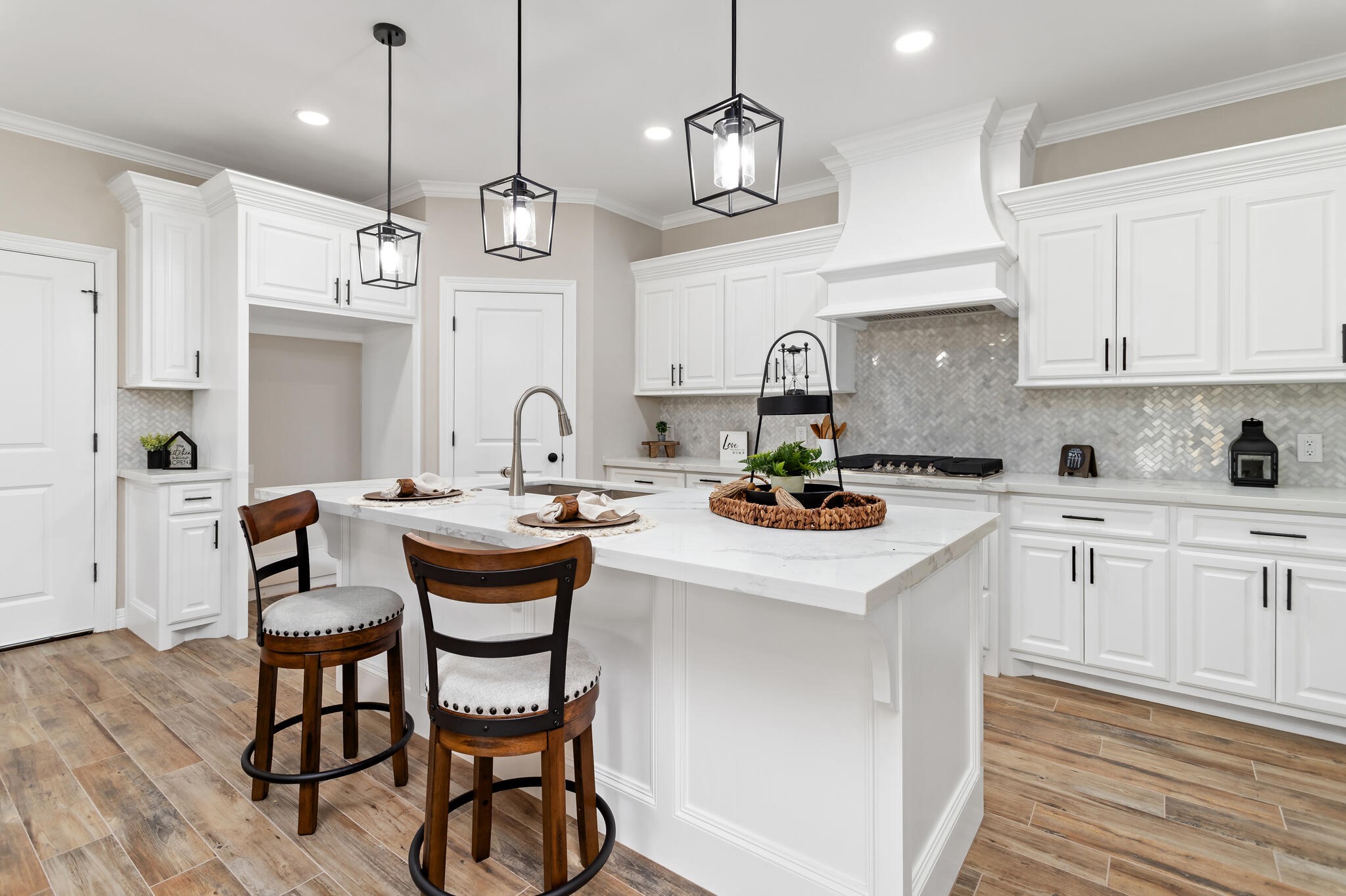 1813 Ordway Street Port Neches, TX 77651 - Photo 12 of 32 a kitchen with stainless steel appliances kitchen island granite countertop a sink a stove a dining table and chairs with wooden floor