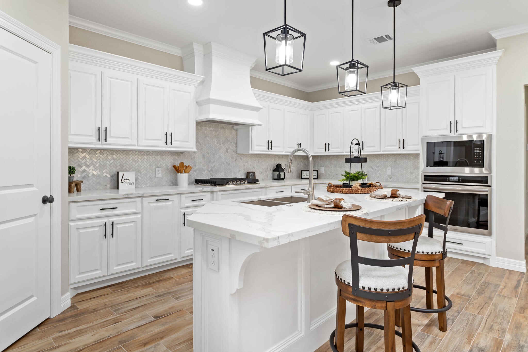 1813 Ordway Street Port Neches, TX 77651 - Photo 7 of 32 a kitchen with stainless steel appliances kitchen island granite countertop a sink and a white stove top oven with white cabinets