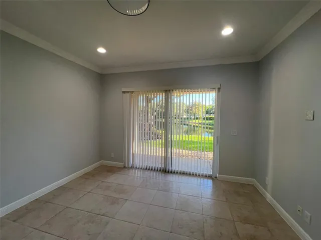 a view of an empty room with glass door
