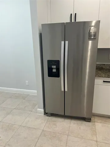 a refrigerator freezer sitting in a kitchen