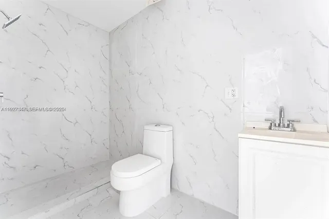 a bathroom with a toilet a sink and a shower