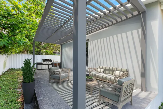 a balcony with furniture and a potted plant