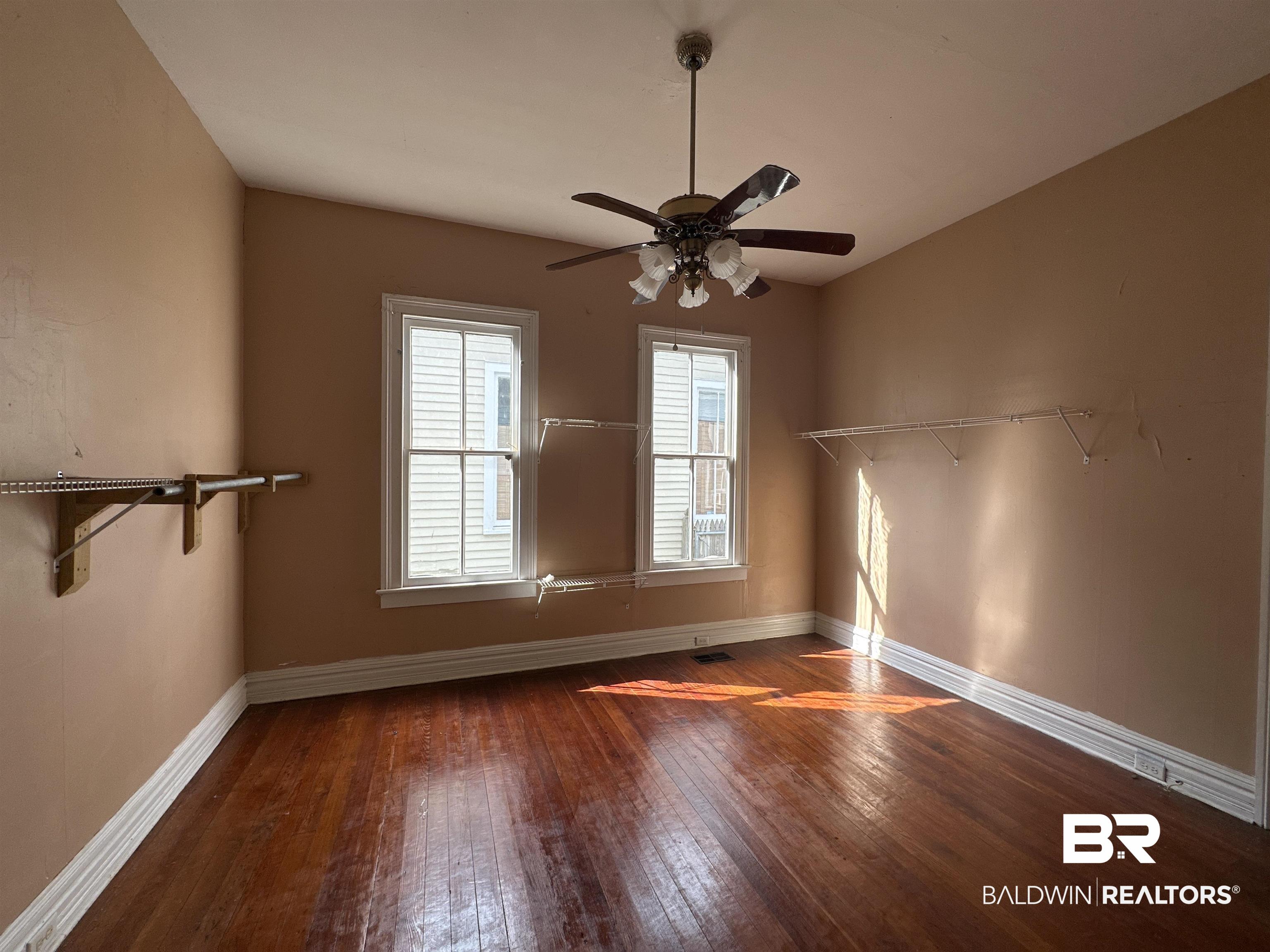 1119 Old Shell Road Mobile, AL 36604 - Photo 10 of 22 Empty room featuring dark hardwood / wood-style floors and ceiling fan