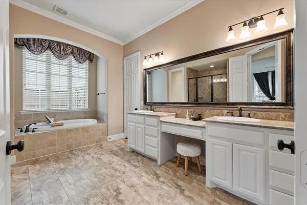 a spacious bathroom with a sink mirror and a bathtub