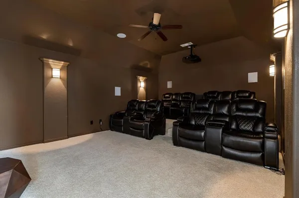 a big room with chandelier entryway and windows