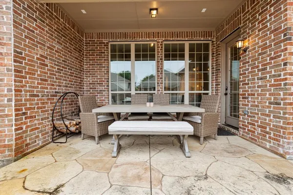 a building outdoor space with patio furniture and potted plants