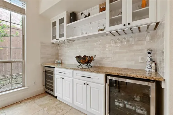 a bathroom with a granite countertop sink a mirror and cabinets
