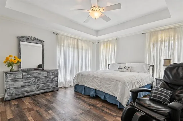 a spacious bedroom with a bed and a chandelier