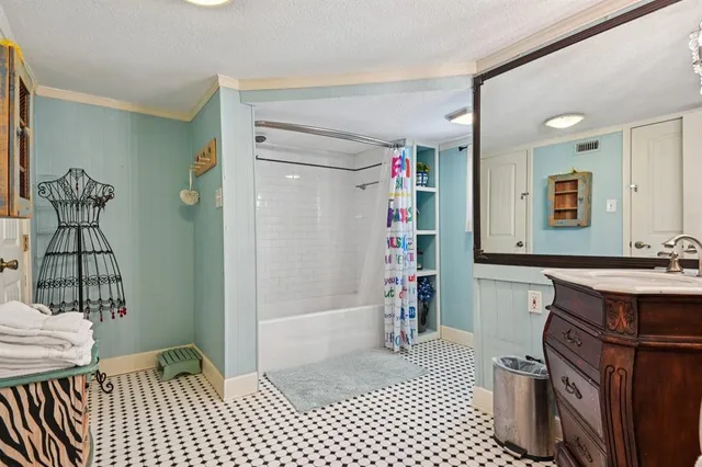 a bathroom with a sink a mirror and shower