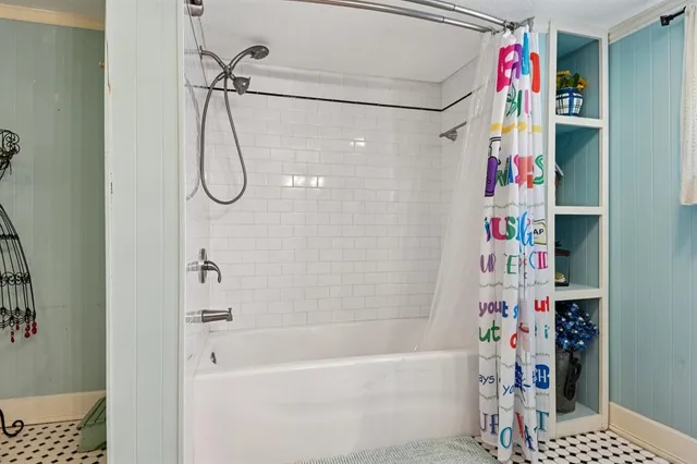 a bathroom with a bathtub and a shower