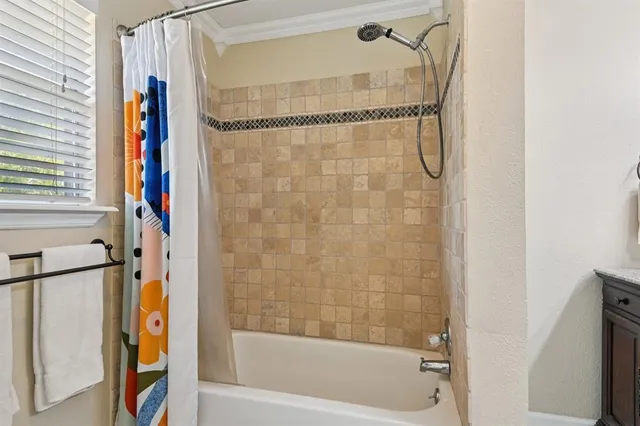 a bathroom with a bathtub and a shower