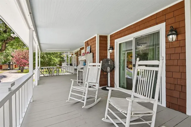 a view of a chairs and table in the balcony