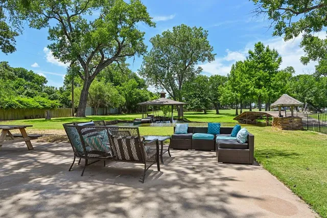 a view of a chair and table in the garden