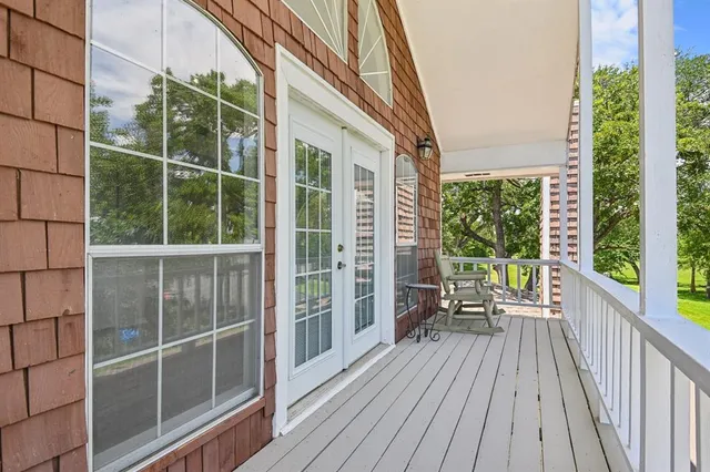 a view of balcony with wooden floor