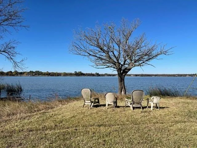 a view of yard with outdoor seating and covered with trees