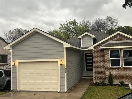 a front view of a house with garage