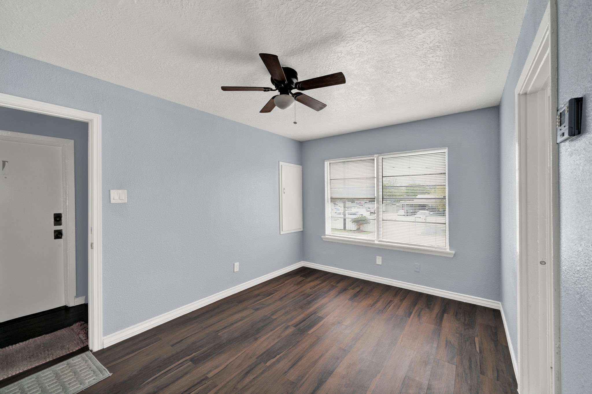 904 Beverly Avenue, Unit 6 Pasadena, TX 77506 - Photo 2 of 32 a view of an empty room with wooden floor and a window