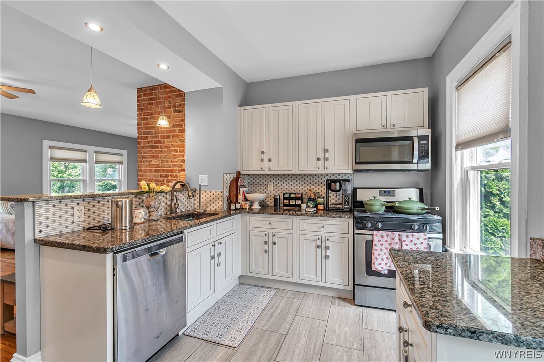 11 15th Street Buffalo, NY 14213 - Photo 12 of 35 Lower - wider shot of the kitchen. Nice exposed brick!