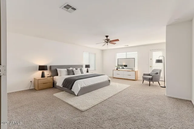 an empty room with a window and a ceiling fan