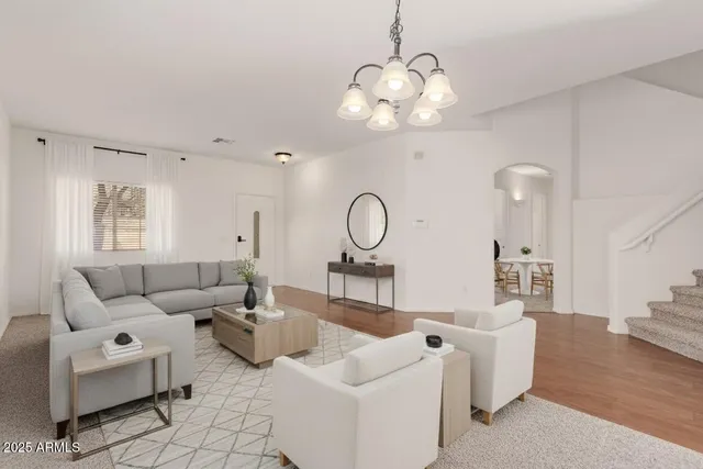 a view of a livingroom with wooden floor and a ceiling fan