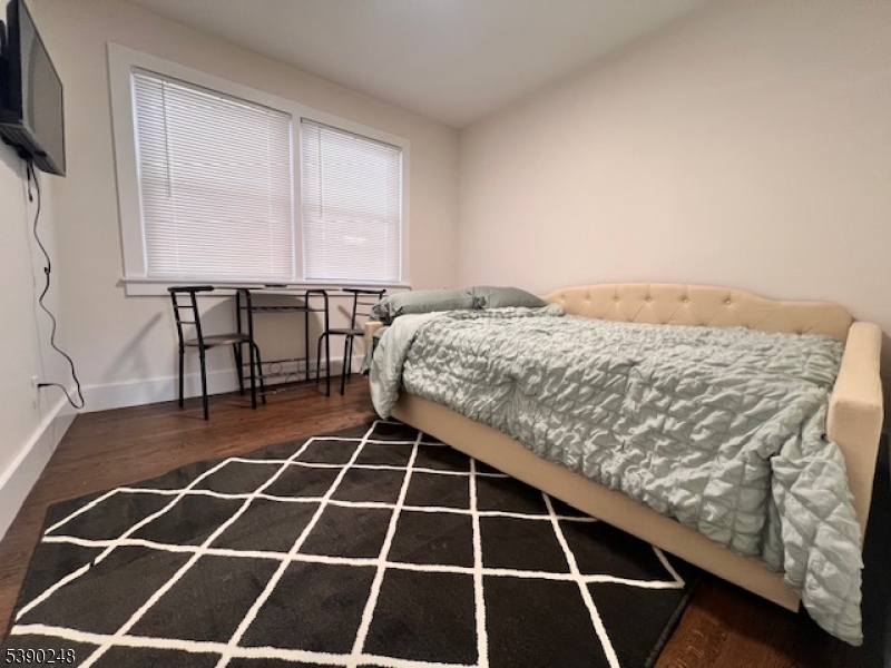 275 Valley Road Clark, NJ 07066 - Photo 8 of 14 a room with a black white checkered floor and a flat screen tv