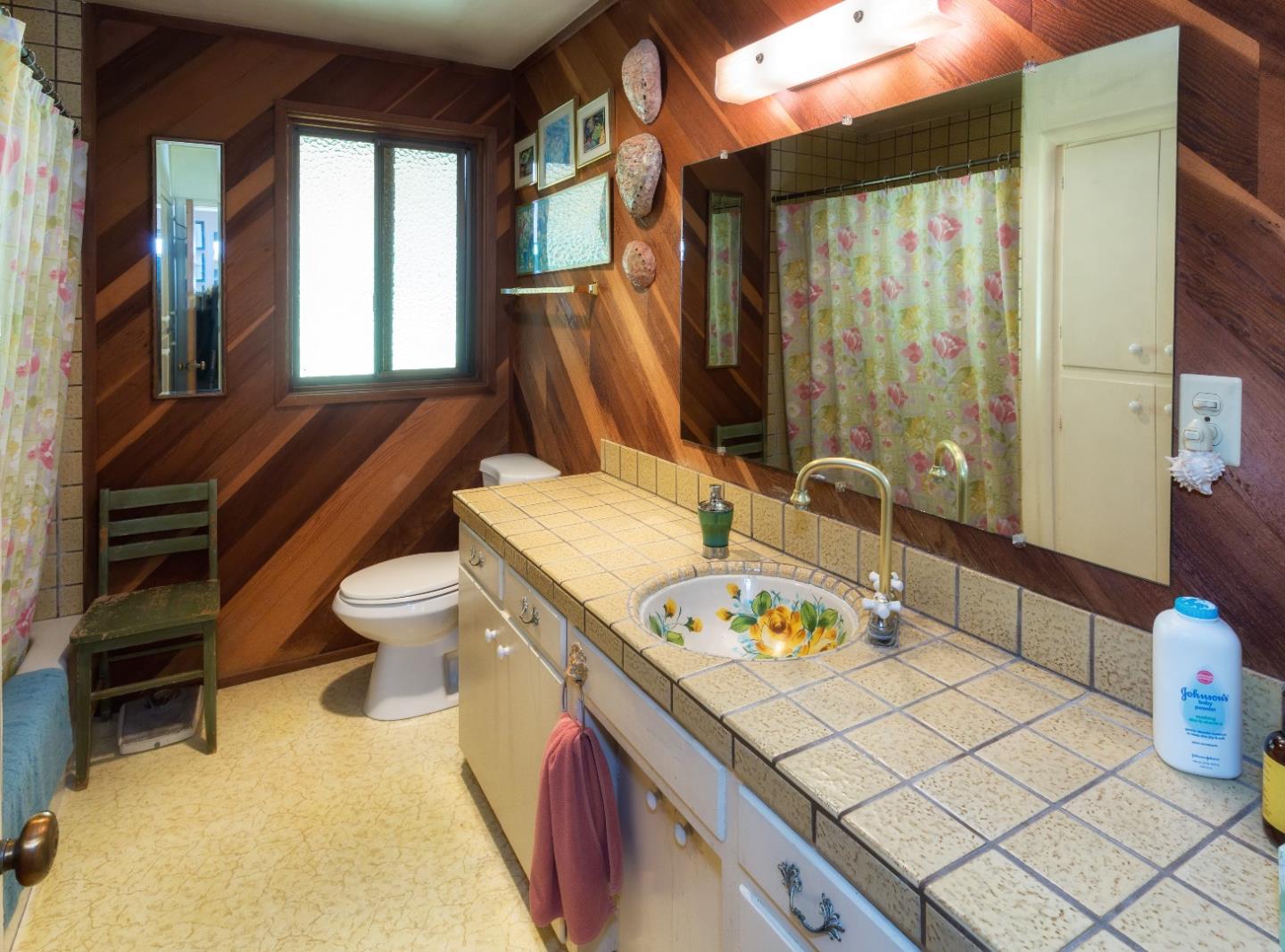 875 Calabasas Road Watsonville, CA 95076 - Photo 29 of 34 a spacious bathroom with a granite countertop sink and a large mirror