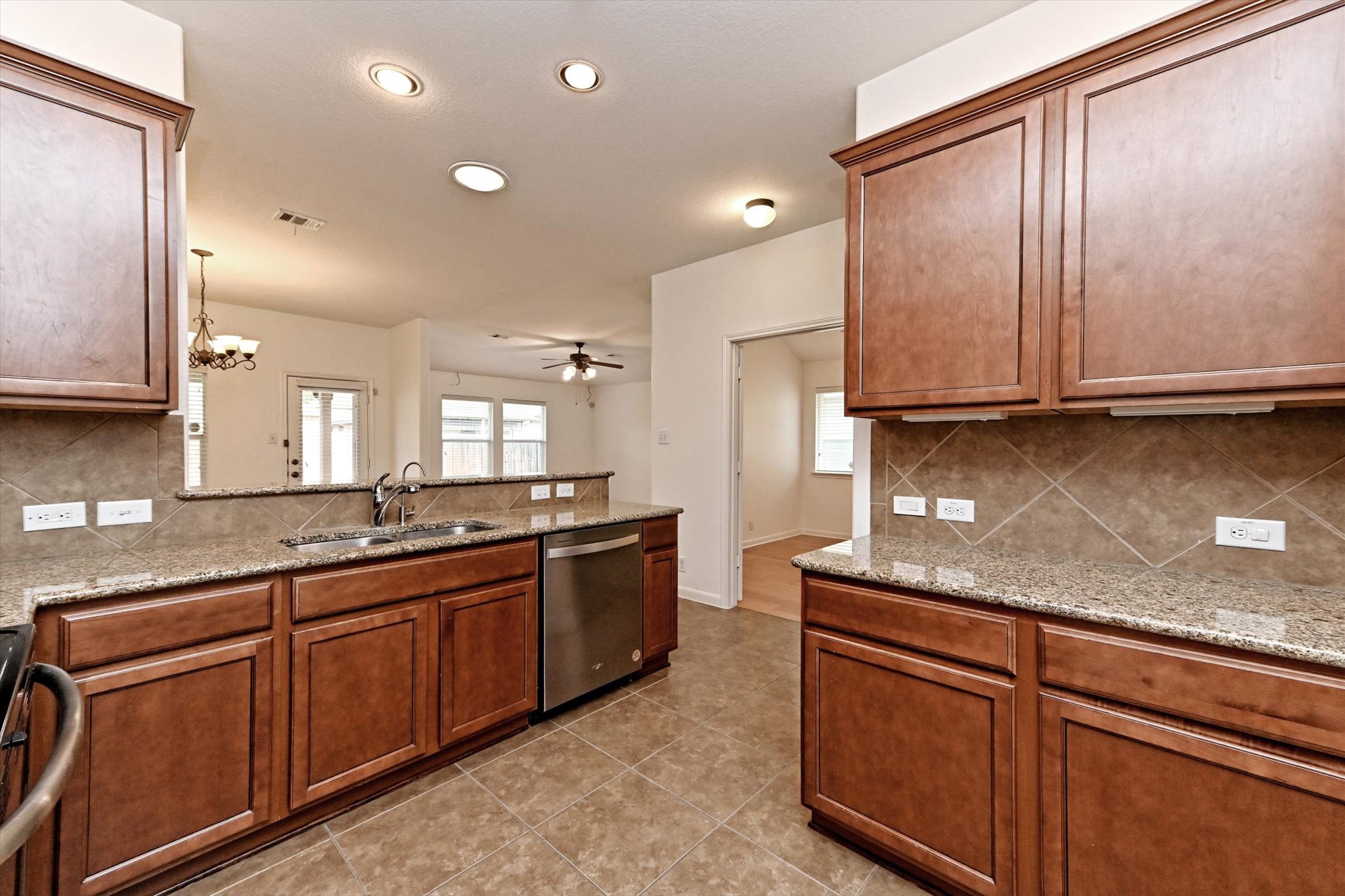 1921 Conn Creek Road Cedar Park, TX 78613 - Photo 14 of 40 a kitchen with stainless steel appliances granite countertop wooden cabinets a sink and dishwasher