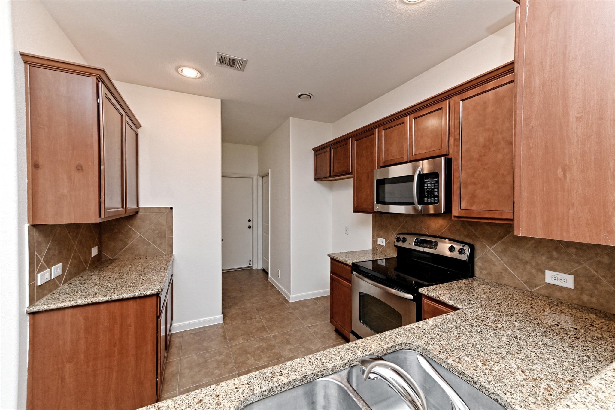 1921 Conn Creek Road Cedar Park, TX 78613 - Photo 15 of 40 a kitchen with stainless steel appliances granite countertop a stove a sink and a refrigerator