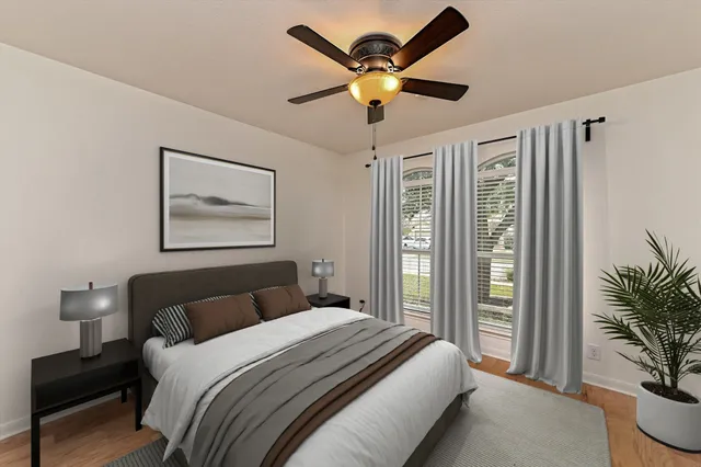 a bedroom with a large bed and a chandelier