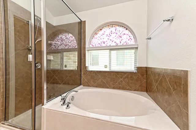 a bathroom with a bathtub and shower