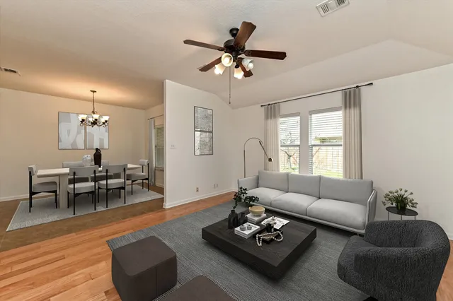a living room with furniture a rug and a window