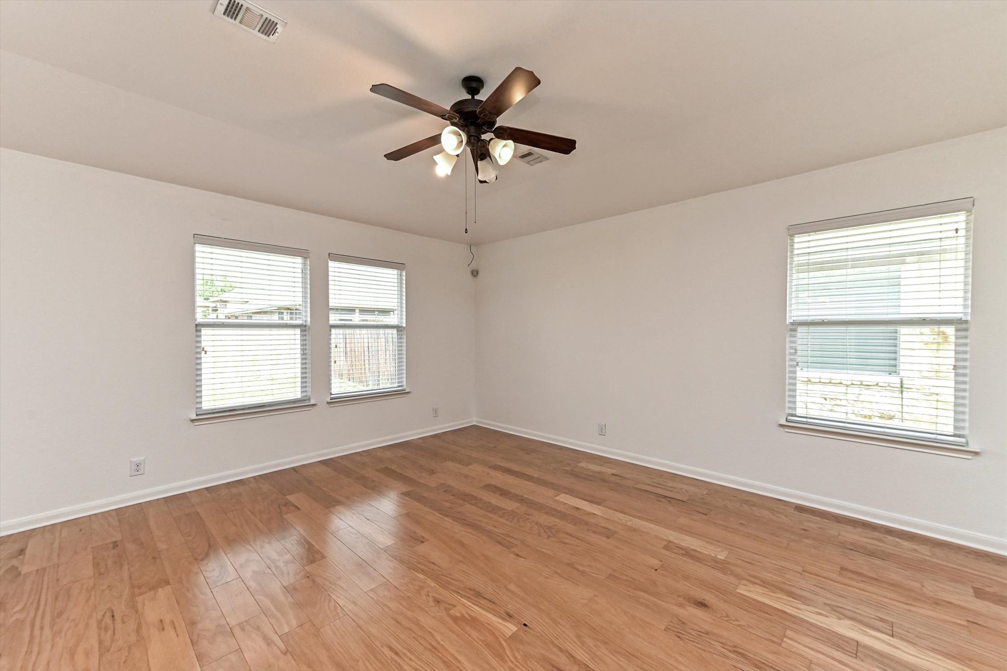 1921 Conn Creek Road Cedar Park, TX 78613 - Photo 6 of 40 a view of an empty room with wooden floor and a window