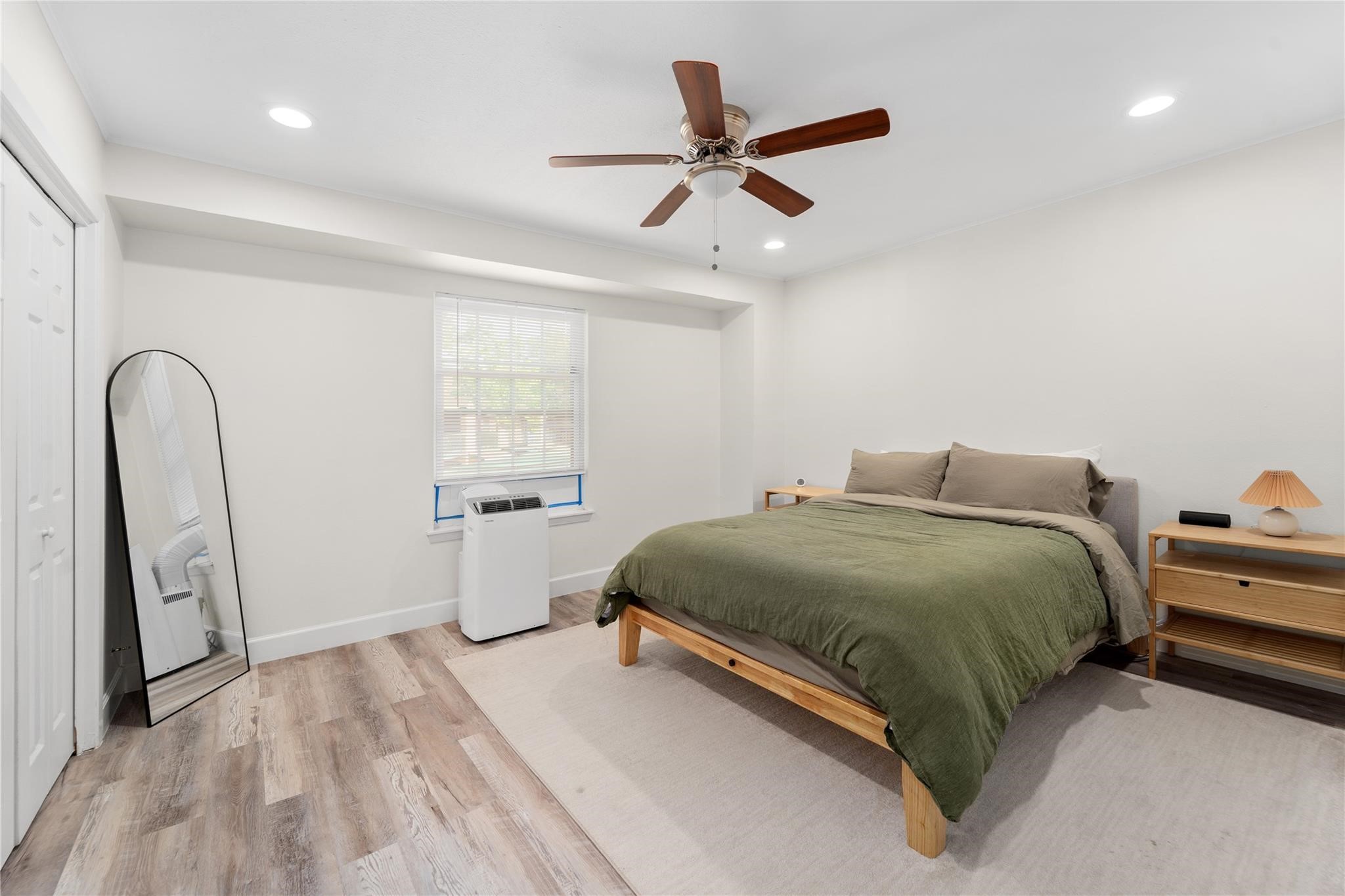 8223 Kingsbrook Road, Unit 212 Houston, TX 77024 - Photo 7 of 10 a bedroom with a bed and a large window