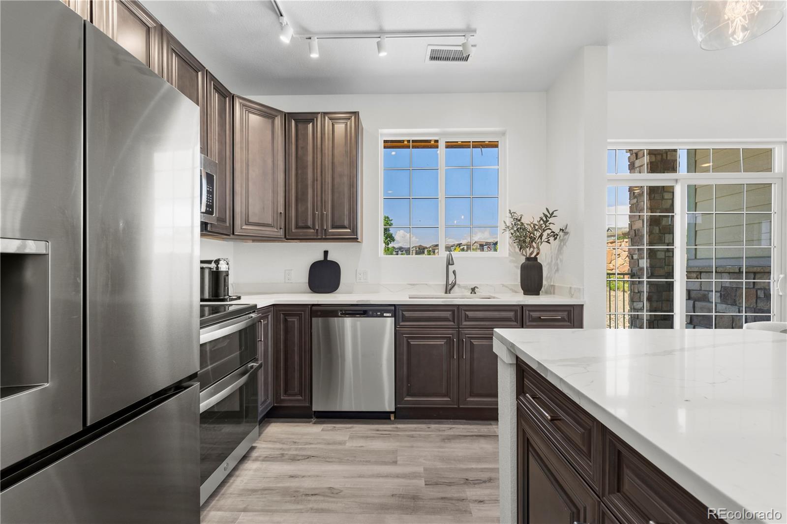 18645 Stroh Road, Unit 2208 Parker, CO 80134 - Photo 18 of 32 a kitchen with stainless steel appliances granite countertop a sink stove and refrigerator