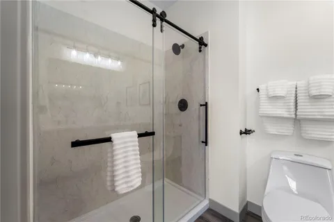 a bathroom with a sink double vanity granite tub shower and a mirror