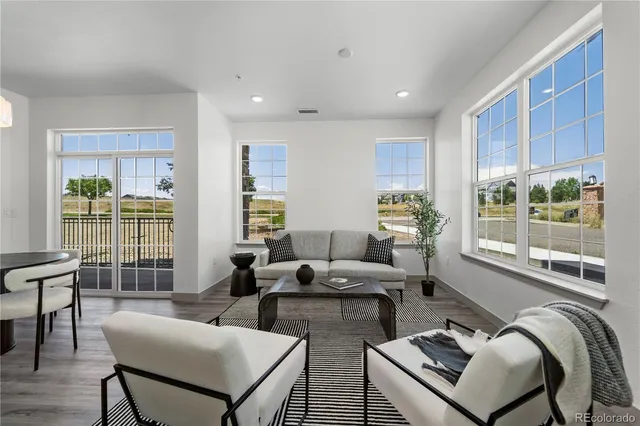 a living room with furniture and two window