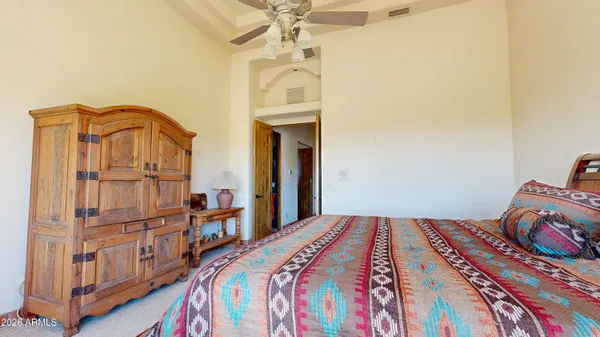 a bedroom with furniture and large windows