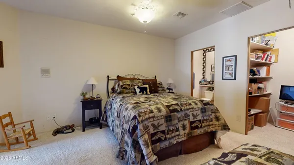 a bathroom with a granite countertop sink mirror vanity and toilet