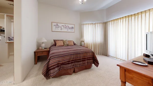 a bedroom with a bed and a dresser