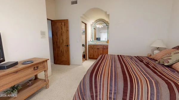 a bathroom with a granite countertop sink a toilet a mirror and shower