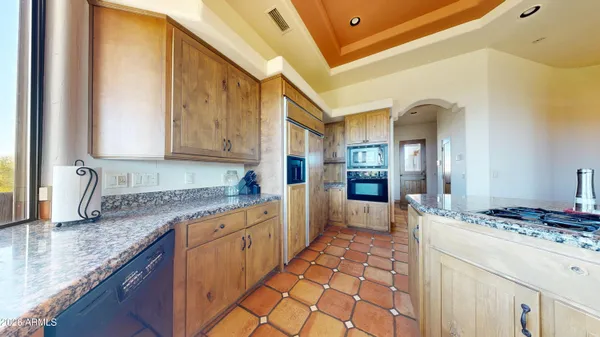 a kitchen with stainless steel appliances granite countertop a sink stove and cabinets