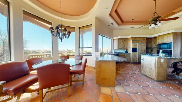 a living room with fireplace furniture and a large window