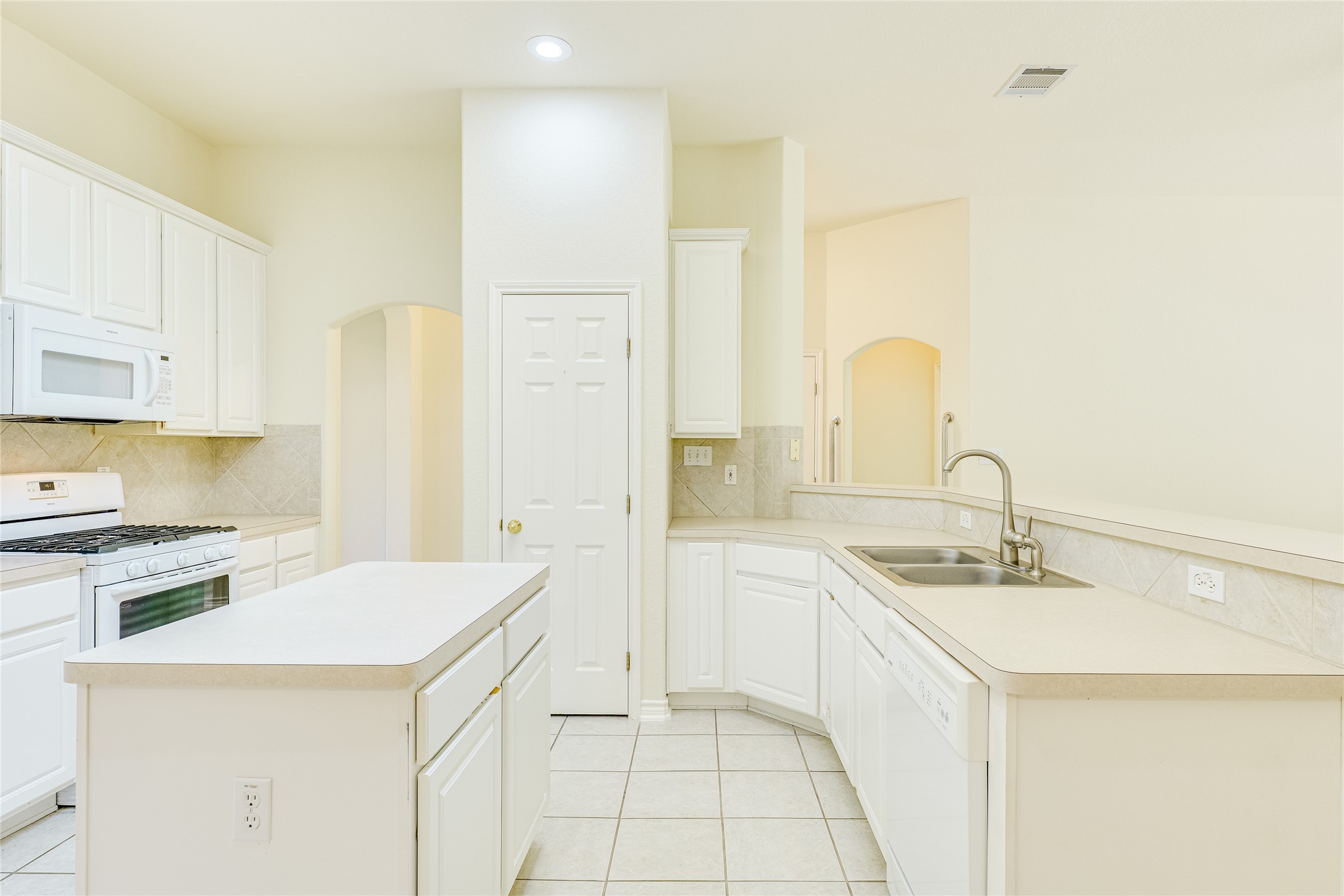 111 Arrowhead Lane Georgetown, TX 78628 - Photo 18 of 40 a kitchen with a sink and white cabinets