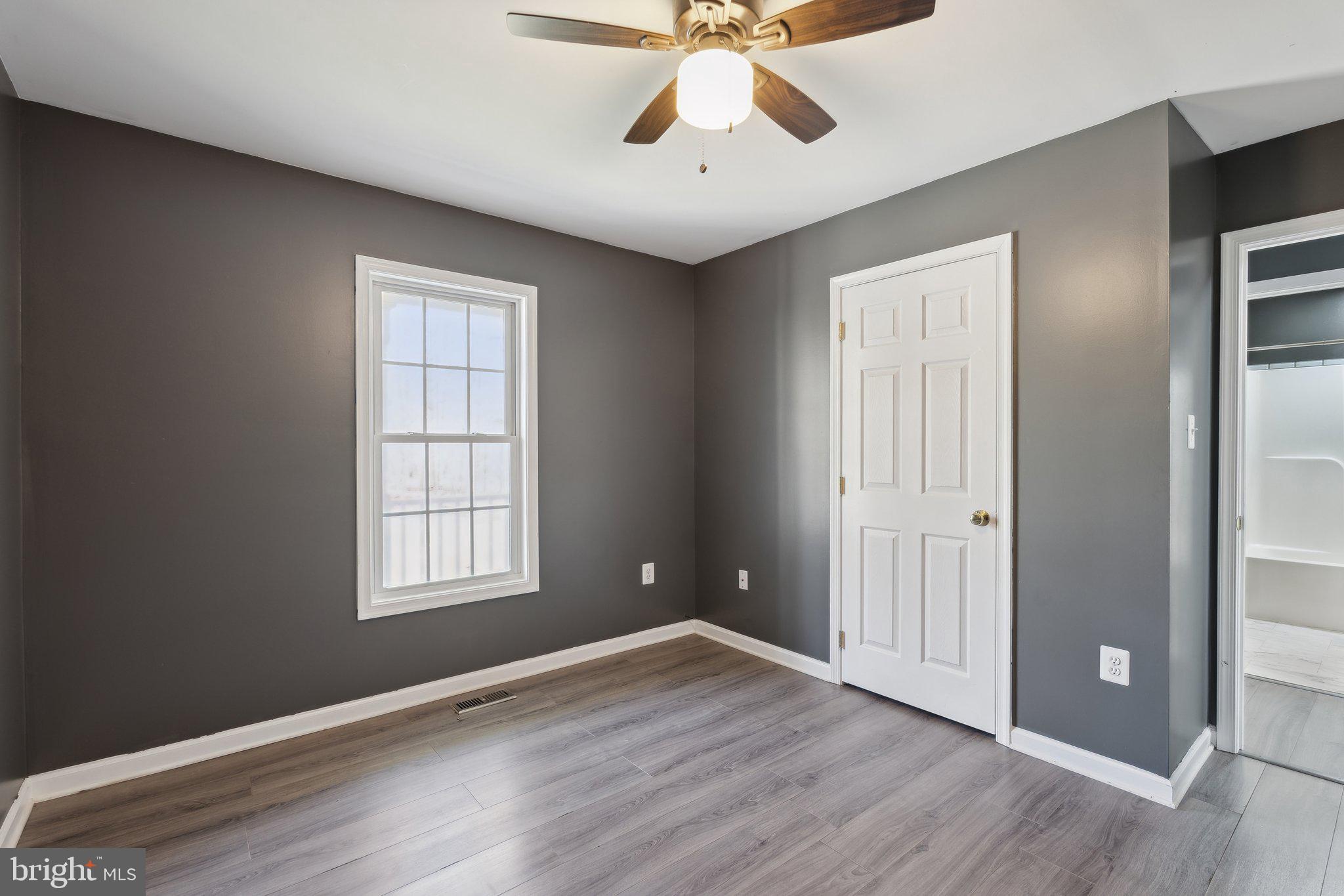 6169 Vance Lane Culpeper, VA 22701 - Photo 17 of 44 an empty room with wooden floor chandelier fan and windows