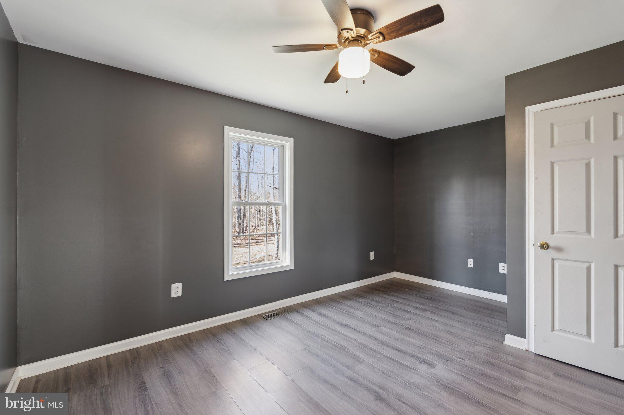 6169 Vance Lane Culpeper, VA 22701 - Photo 18 of 44 wooden floor in an empty room with a window