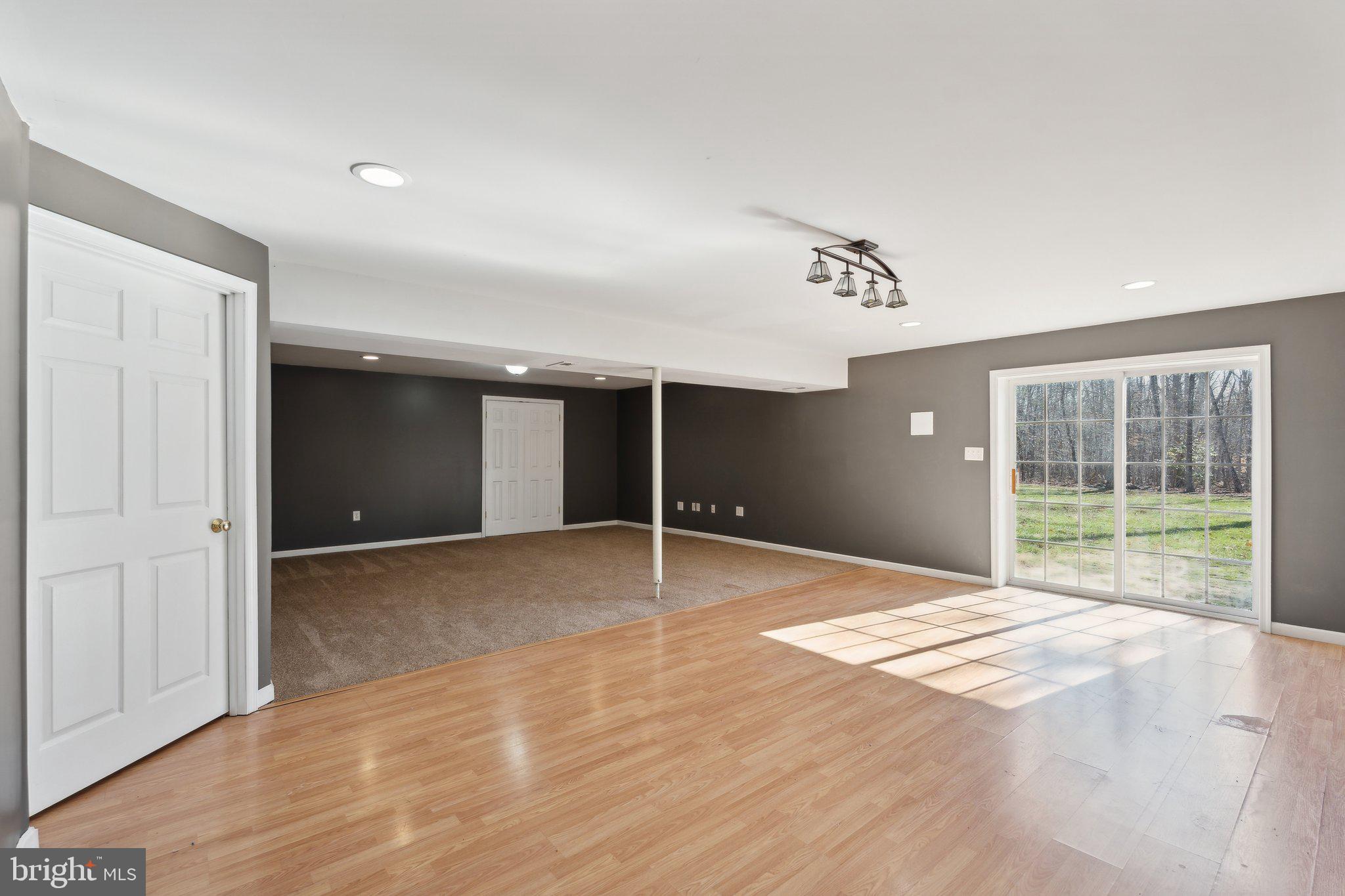 6169 Vance Lane Culpeper, VA 22701 - Photo 23 of 44 a view of an empty room with wooden floor and a window