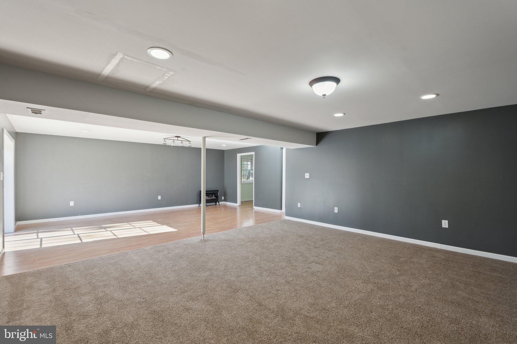 6169 Vance Lane Culpeper, VA 22701 - Photo 25 of 44 a view of an empty room with glass door and chandelier fan