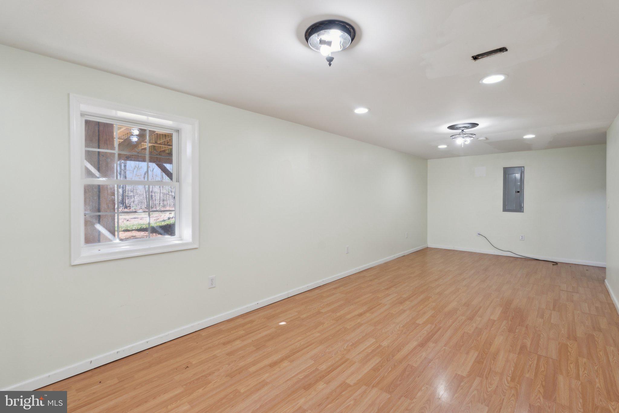 6169 Vance Lane Culpeper, VA 22701 - Photo 26 of 44 a view of an empty room with wooden floor and a window
