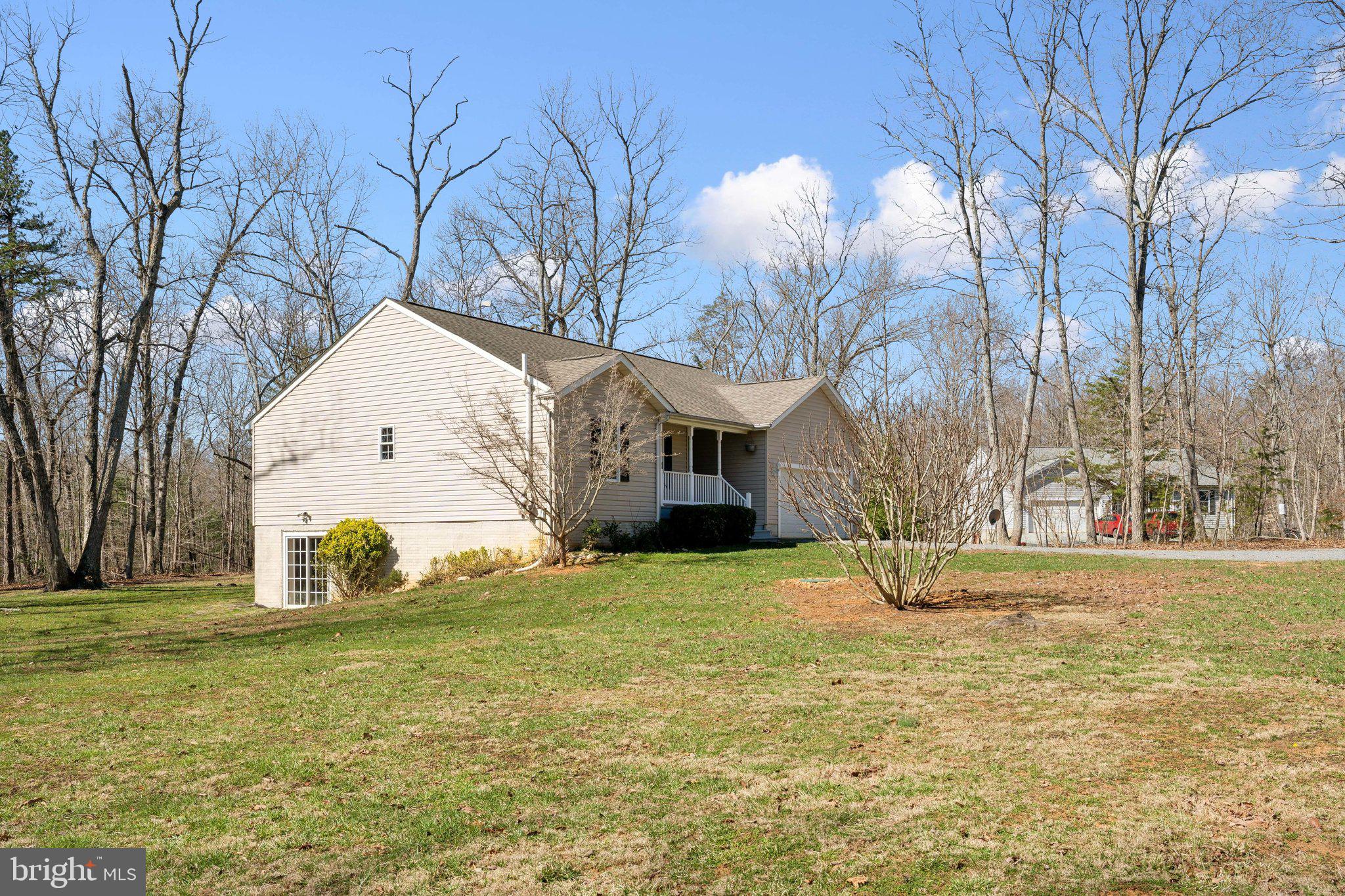 6169 Vance Lane Culpeper, VA 22701 - Photo 32 of 44 a view of a white house with a yard